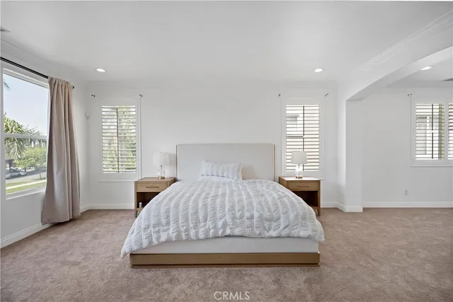 a bedroom with a large bed and a window