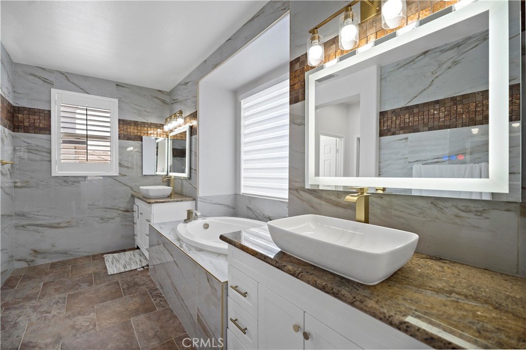 11855 Modena Drive Rancho Cucamonga, CA 91701 - Photo 19 of 30 a bath room with a sink and a mirror