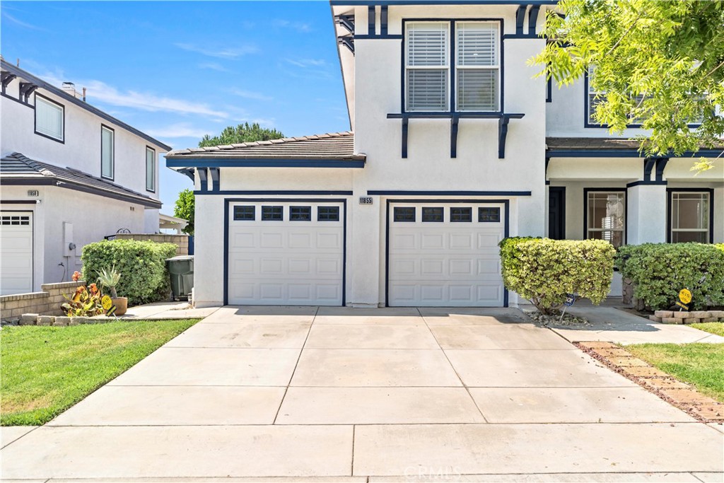 11855 Modena Drive Rancho Cucamonga, CA 91701 - Photo 2 of 30 a front view of a house with a yard