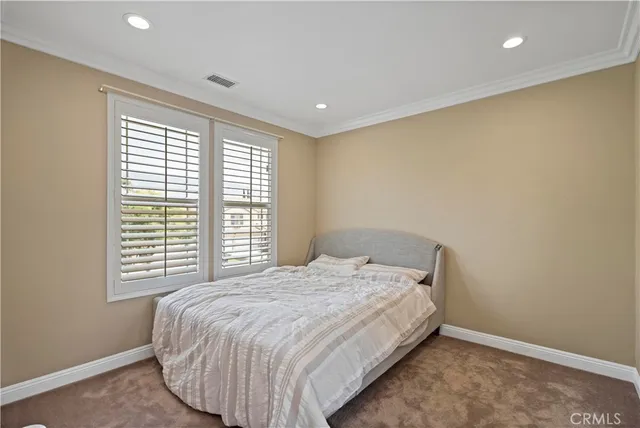 a bed sitting in a room next to a window