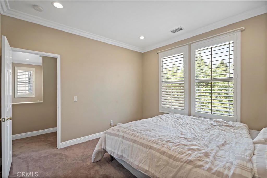 11855 Modena Drive Rancho Cucamonga, CA 91701 - Photo 23 of 30 a bedroom with a bed and a window