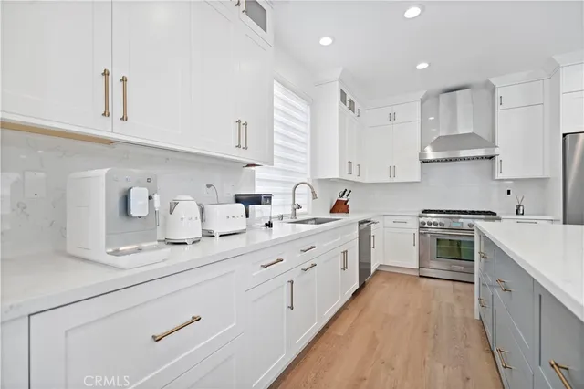a kitchen with kitchen island granite countertop white cabinets white stainless steel appliances with a sink and dishwasher