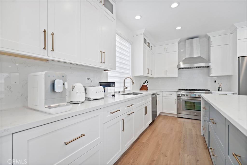 11855 Modena Drive Rancho Cucamonga, CA 91701 - Photo 10 of 30 a kitchen with kitchen island granite countertop white cabinets white stainless steel appliances with a sink and dishwasher