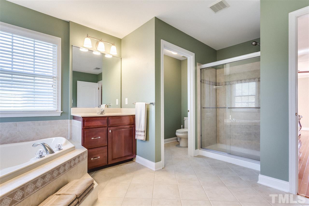 9004 Shellwood Court Raleigh, NC 27617 - Photo 13 of 25 a bathroom with a tub sink and mirror