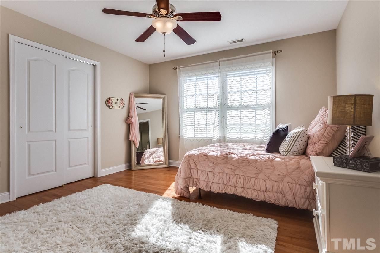 9004 Shellwood Court Raleigh, NC 27617 - Photo 15 of 25 a bedroom with a bed and wooden floor