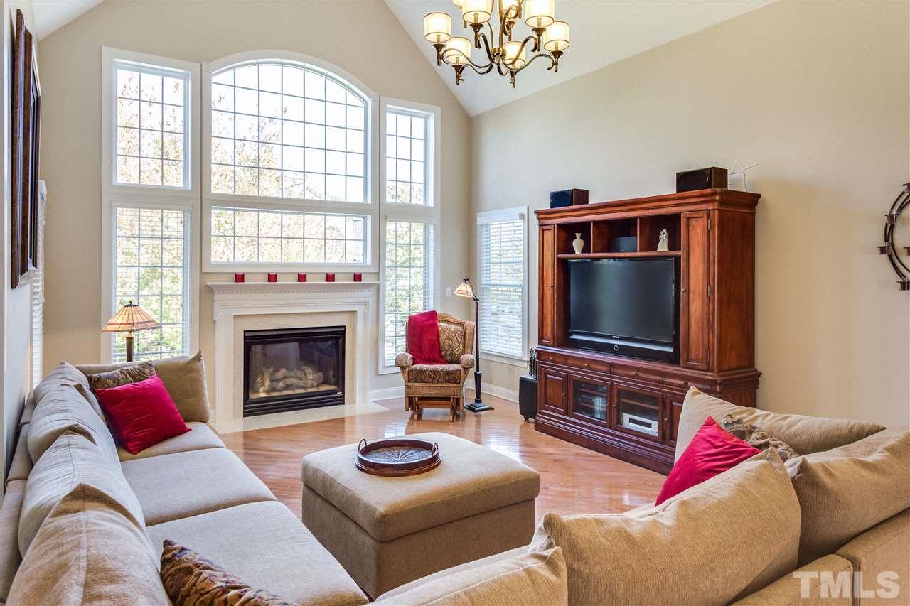 9004 Shellwood Court Raleigh, NC 27617 - Photo 6 of 25 a living room with furniture a flat screen tv and a fireplace