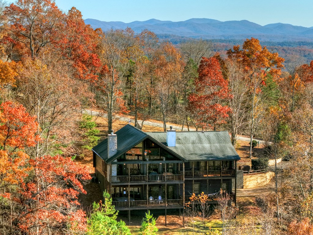 180 Cinnamon Bear Road Mineral Bluff, GA 30559 - Photo 20 of 76 a view of a large house with a mountain and trees in the background