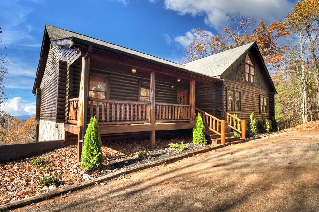 180 Cinnamon Bear Road Mineral Bluff, GA 30559 - Photo 24 of 76 a view of a house with a small yard and wooden fence