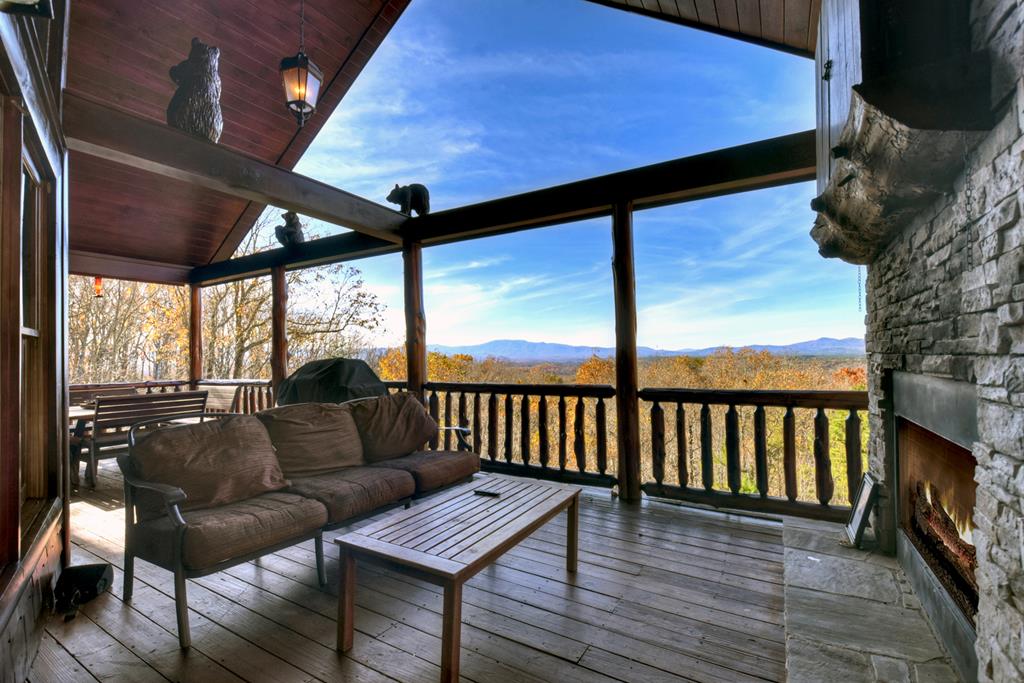180 Cinnamon Bear Road Mineral Bluff, GA 30559 - Photo 29 of 76 a roof deck with wooden floor and outdoor seating