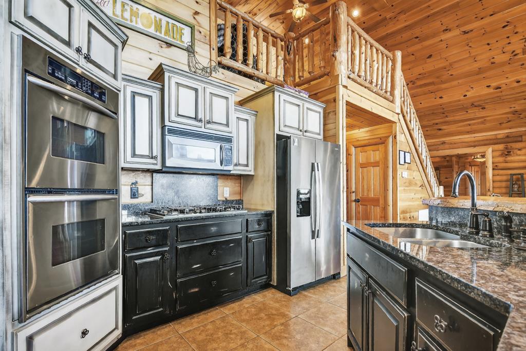 180 Cinnamon Bear Road Mineral Bluff, GA 30559 - Photo 3 of 76 a kitchen with stainless steel appliances granite countertop a stove and a refrigerator