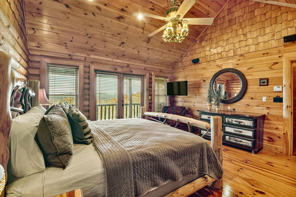 180 Cinnamon Bear Road Mineral Bluff, GA 30559 - Photo 38 of 76 a bed sitting in a bedroom next to a window