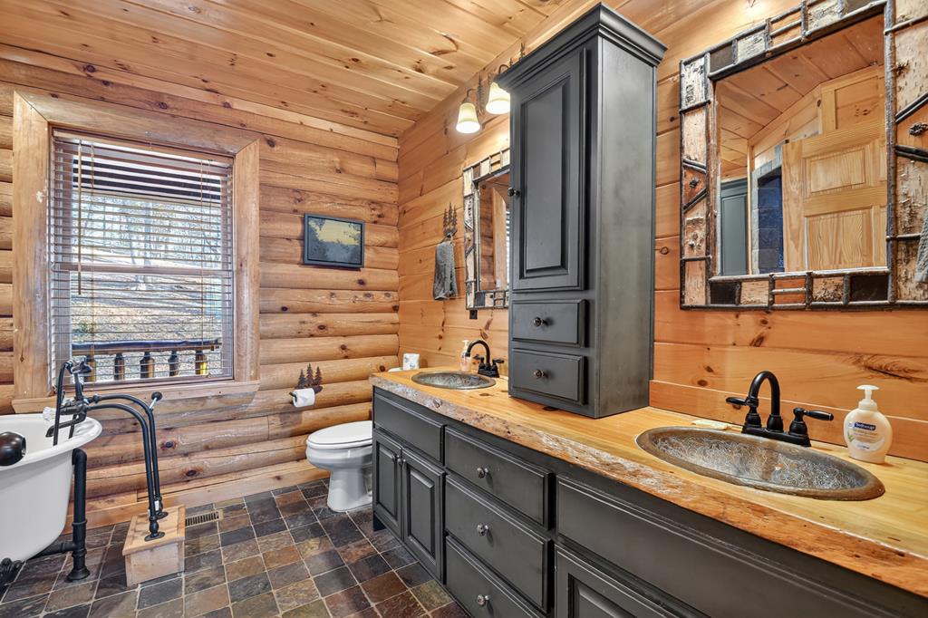 180 Cinnamon Bear Road Mineral Bluff, GA 30559 - Photo 39 of 76 a bathroom with a granite countertop sink mirror and toilet
