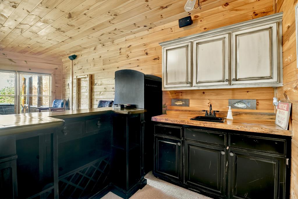 180 Cinnamon Bear Road Mineral Bluff, GA 30559 - Photo 51 of 76 a kitchen with stainless steel appliances granite countertop a sink a stove cabinets and a dining table