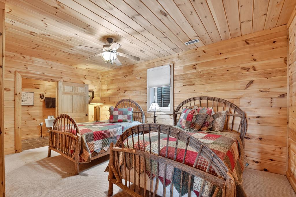 180 Cinnamon Bear Road Mineral Bluff, GA 30559 - Photo 52 of 76 a bedroom with furniture and a chandelier