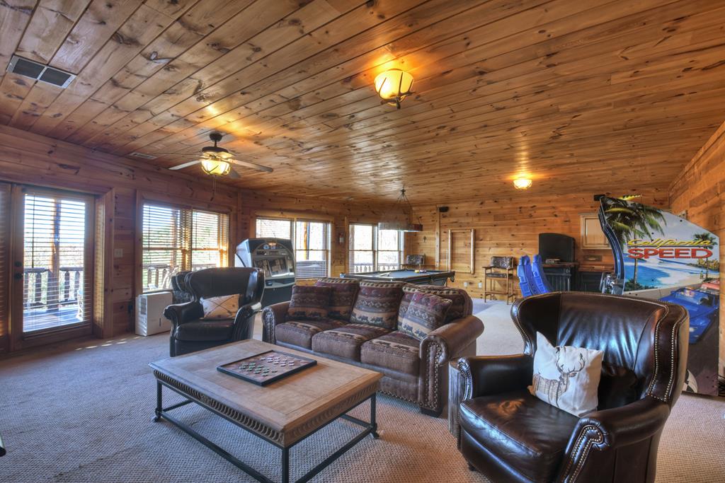 180 Cinnamon Bear Road Mineral Bluff, GA 30559 - Photo 60 of 76 a living room with furniture and a chandelier