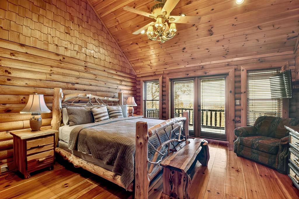 180 Cinnamon Bear Road Mineral Bluff, GA 30559 - Photo 6 of 76 a bedroom with a bed and wooden floor