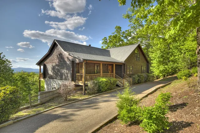 a view of a house with a wooden fence