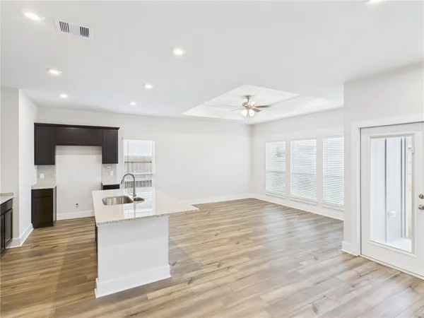 a view of kitchen with sink and natural light