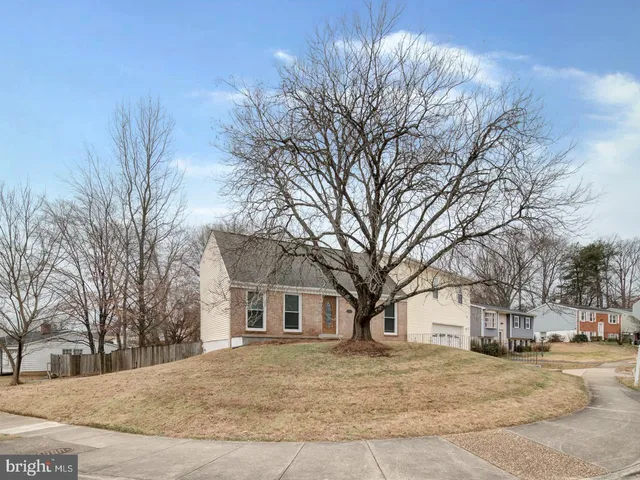 a view of a house with a yard covered in snow