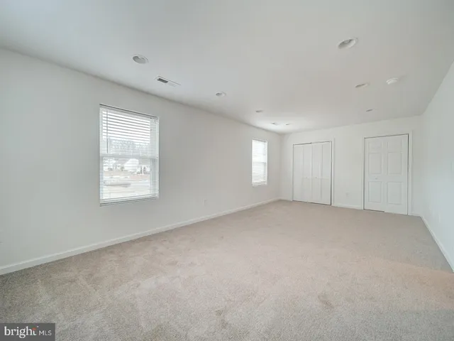 a bathroom with a bathtub shower sink vanity mirror and toilet