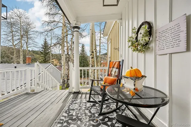 a view of a chairs and table in the balcony