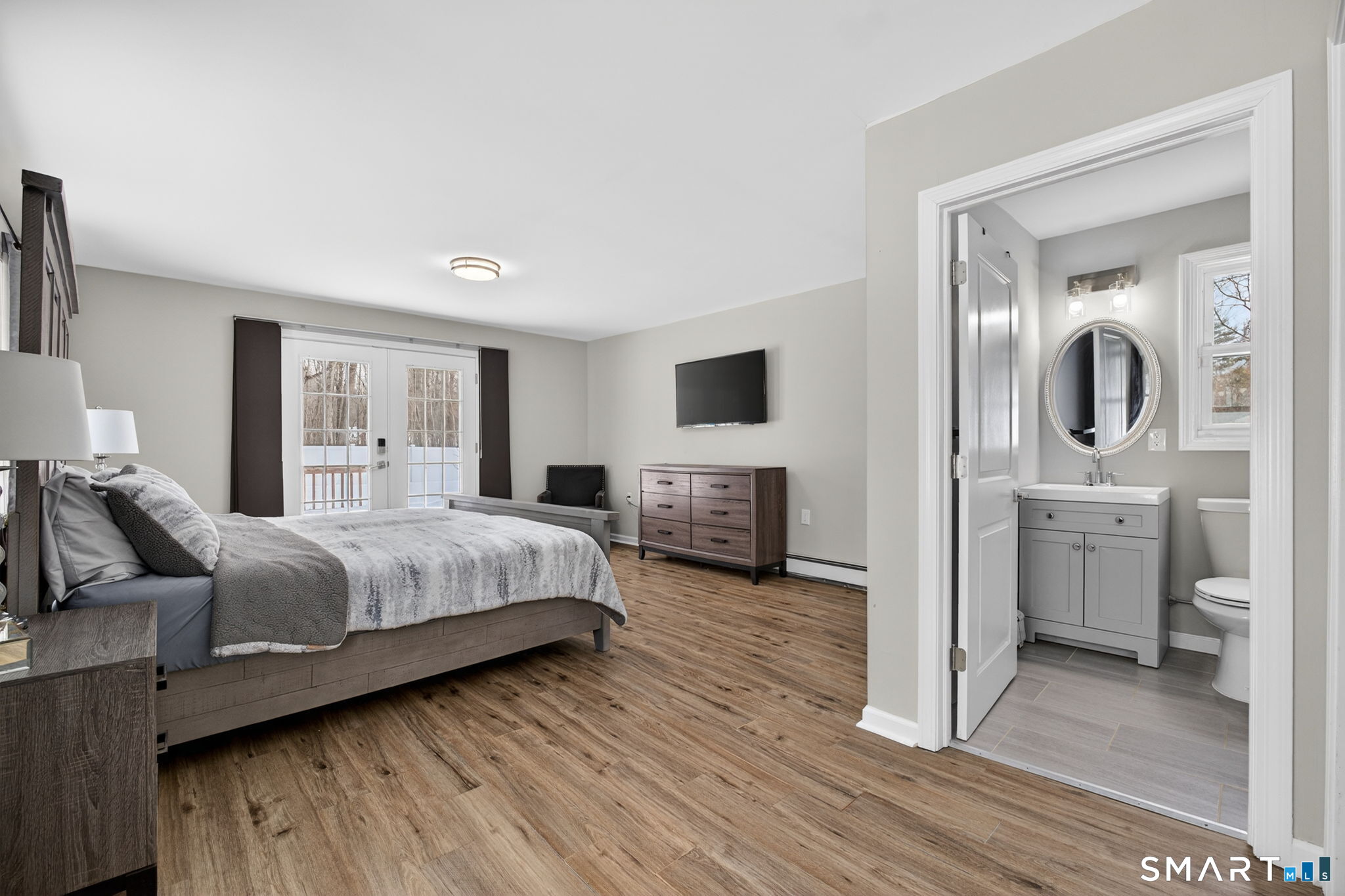 375 Sea Hill Road North Branford, CT 06471 - Photo 16 of 40 a spacious bedroom with a bed and flat screen tv