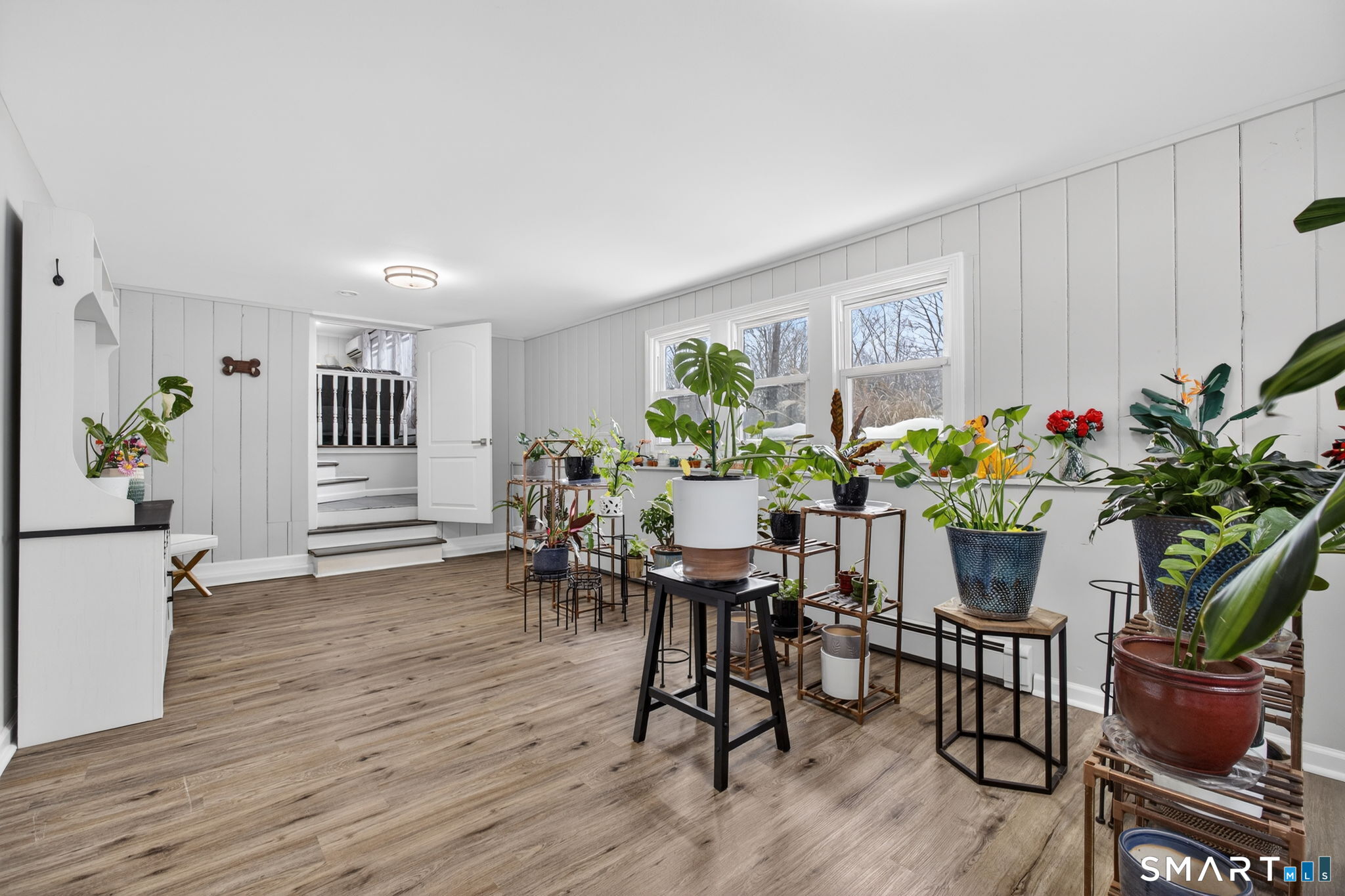375 Sea Hill Road North Branford, CT 06471 - Photo 20 of 40 a dining room with furniture potted plants and wooden floor