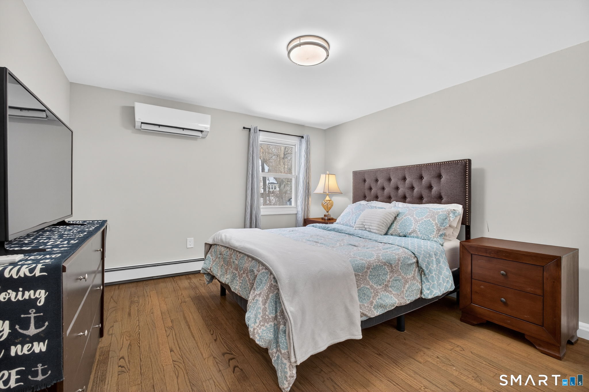 375 Sea Hill Road North Branford, CT 06471 - Photo 23 of 40 a bedroom with a bed and a flat tv screen on a dresser