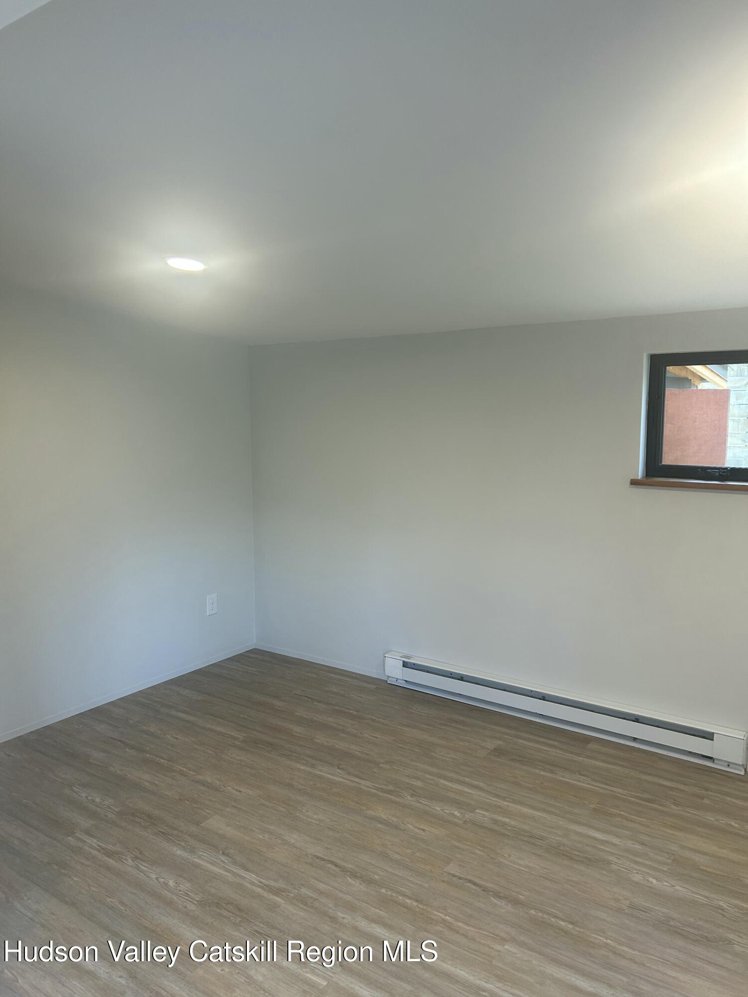 72 Forest Glen Road, Unit STUDIO Gardiner, NY 12561 - Photo 7 of 15 an empty room with wooden floor and windows