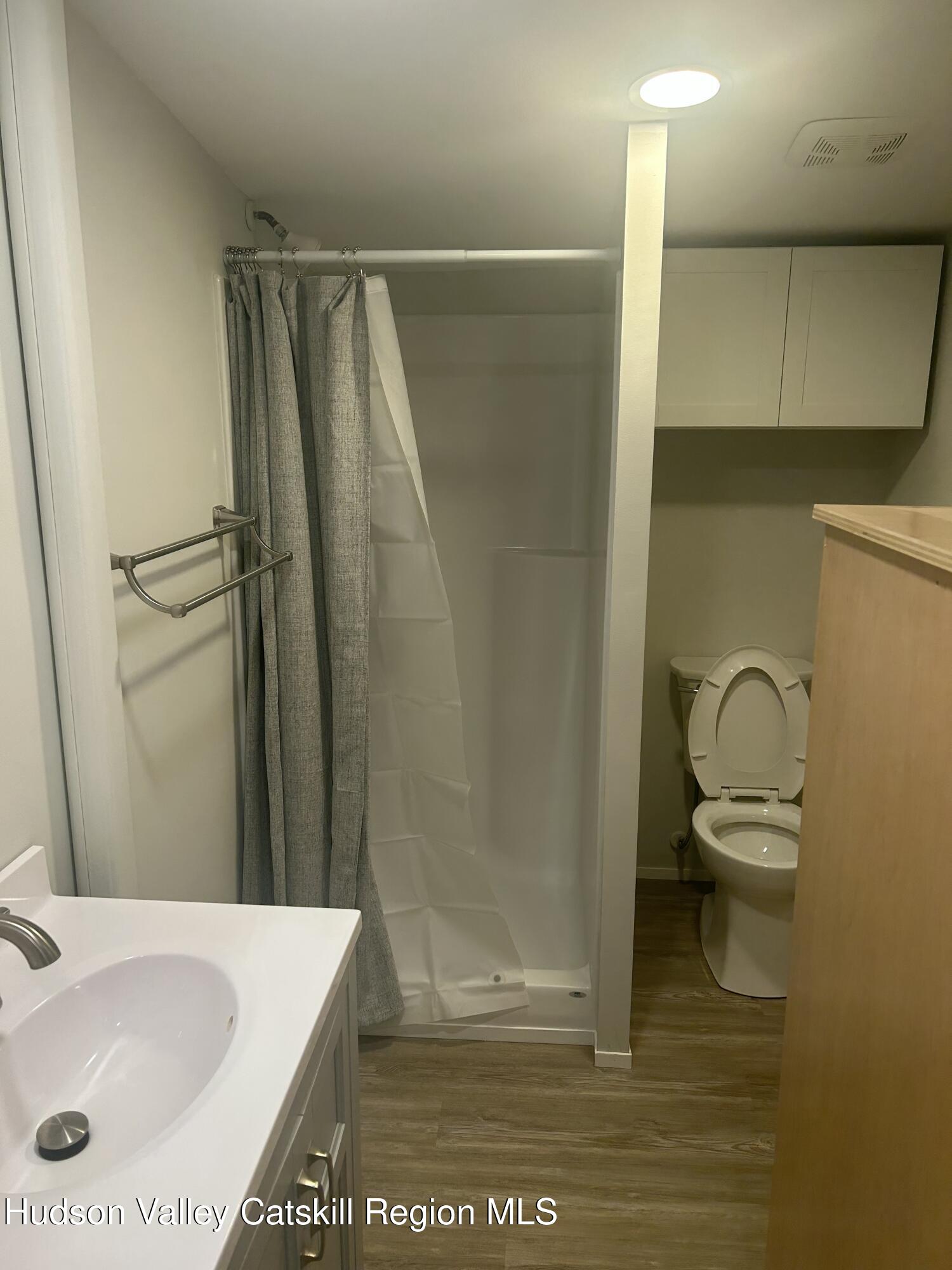 72 Forest Glen Road, Unit STUDIO Gardiner, NY 12561 - Photo 10 of 15 a bathroom with a sink a toilet and shower