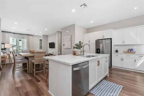 a kitchen with a sink stove and cabinets