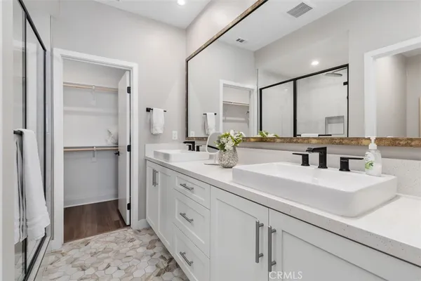 a bathroom with a double vanity sink and mirror