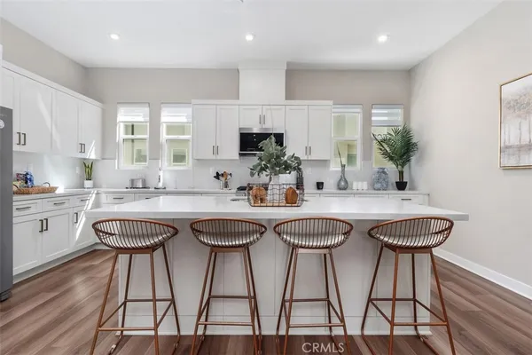 a kitchen with appliances a sink and cabinets