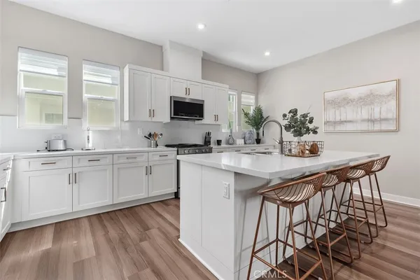 a kitchen with stainless steel appliances granite countertop a sink and cabinets