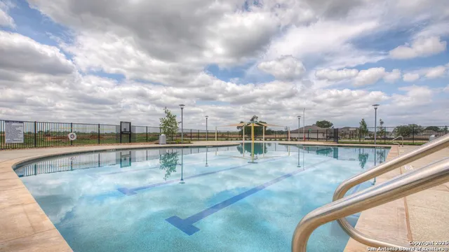 a view of swimming pool with outdoor seating