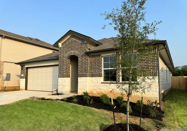 a view of a house with a backyard