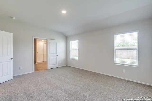 a spacious bathroom with a double vanity sink and mirror