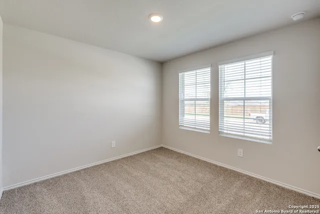 an empty room with windows and closet