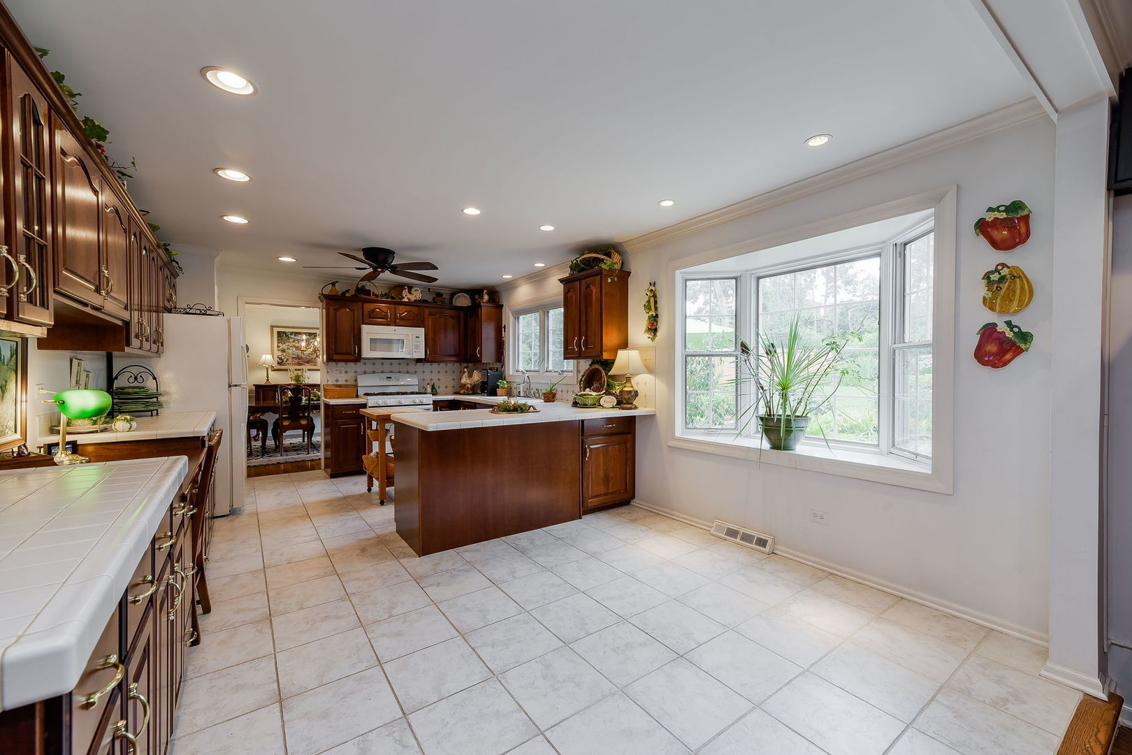 1S771 Carrol Gate Road Wheaton, IL 60189 - Photo 12 of 42 a large kitchen with stainless steel appliances granite countertop a large counter top and a stove top oven