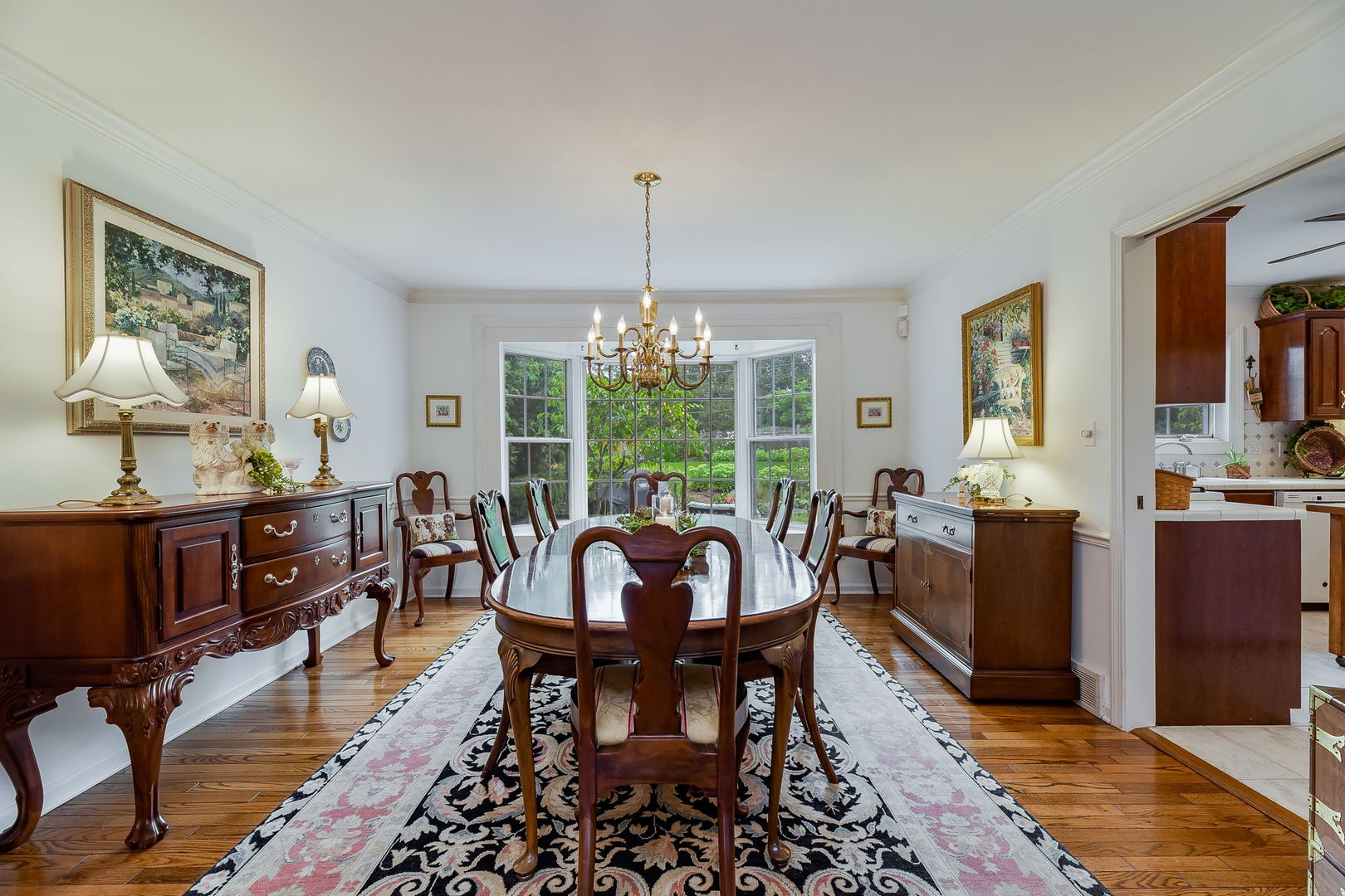 1S771 Carrol Gate Road Wheaton, IL 60189 - Photo 8 of 42 a dining room with furniture a chandelier and wooden floor