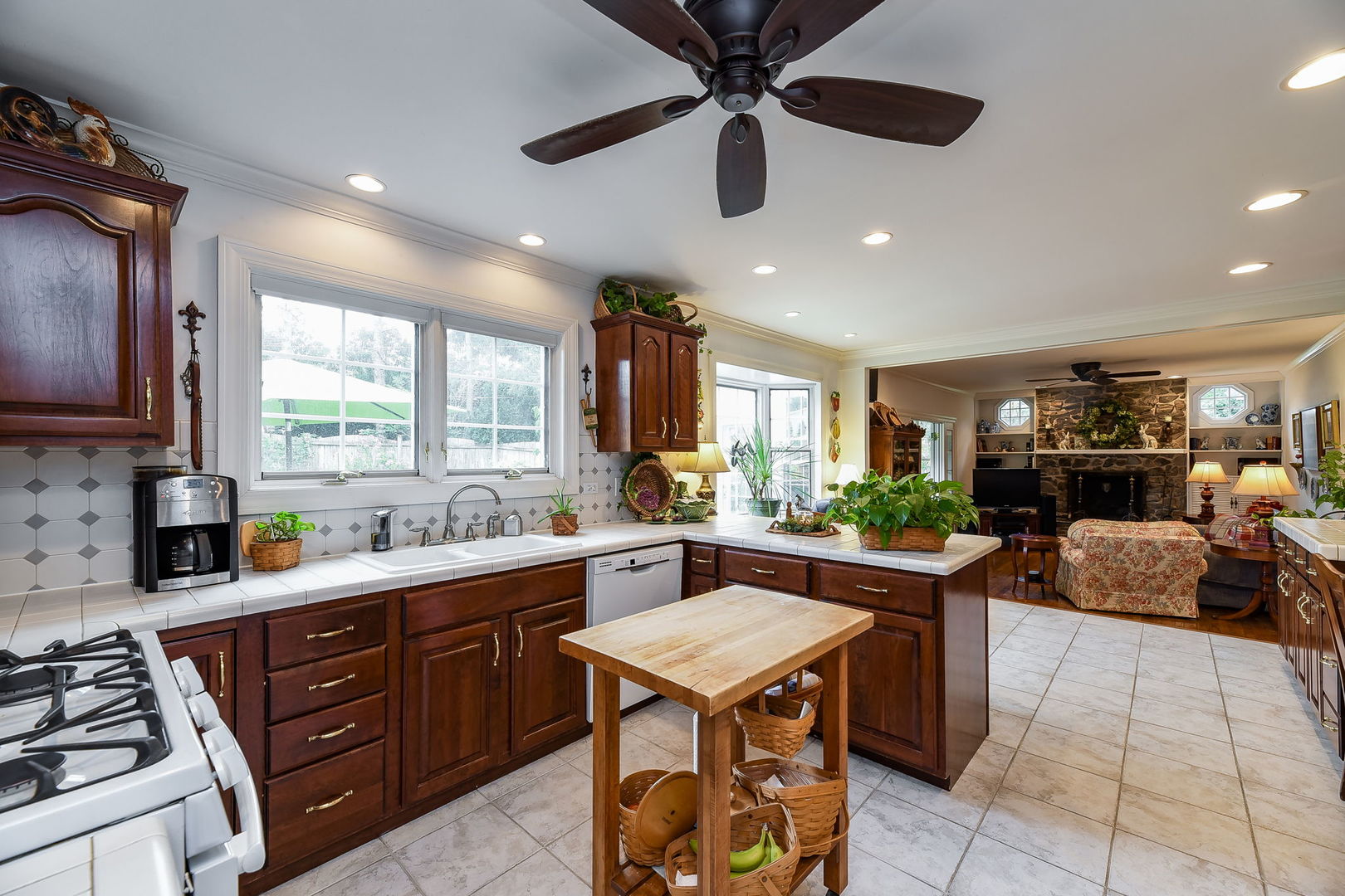 1S771 Carrol Gate Road Wheaton, IL 60189 - Photo 9 of 42 a kitchen with stainless steel appliances granite countertop wooden cabinets a stove a sink a dining table and chairs