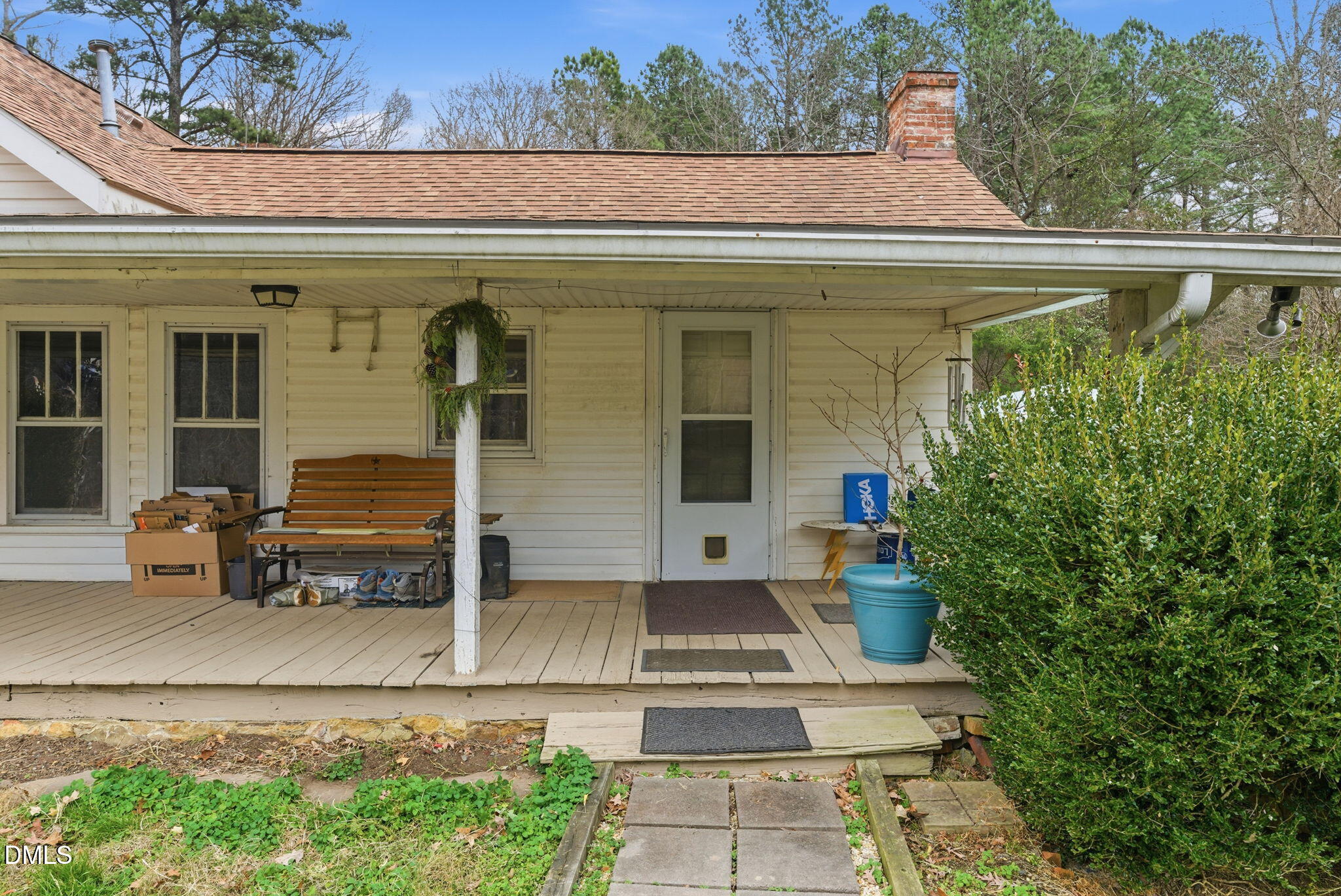 2319 White Cross Road Chapel Hill, NC 27516 - Photo 11 of 28 a view of a white house with large windows and a table and chairs
