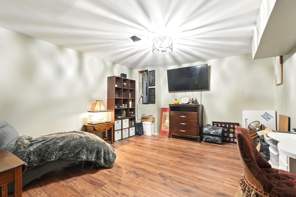 47 Old Chester Road Huntington, MA 01050 - Photo 20 of 36 a bedroom with a bed and a flat tv screen on wall