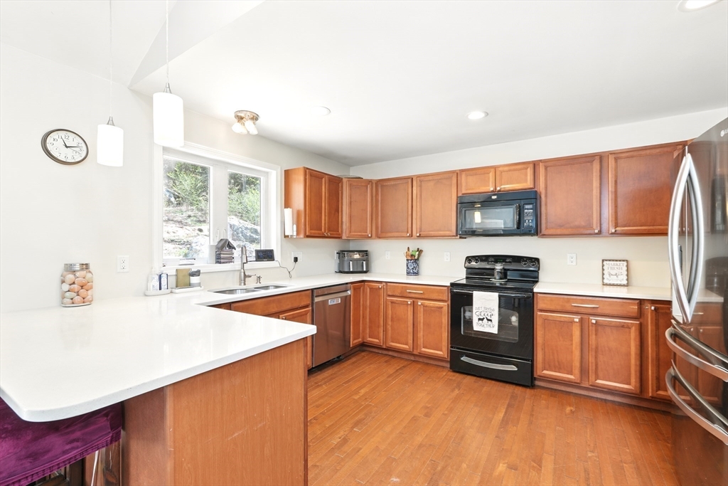 47 Old Chester Road Huntington, MA 01050 - Photo 9 of 36 a kitchen with granite countertop a stove top oven a sink dishwasher and a refrigerator with wooden cabinets