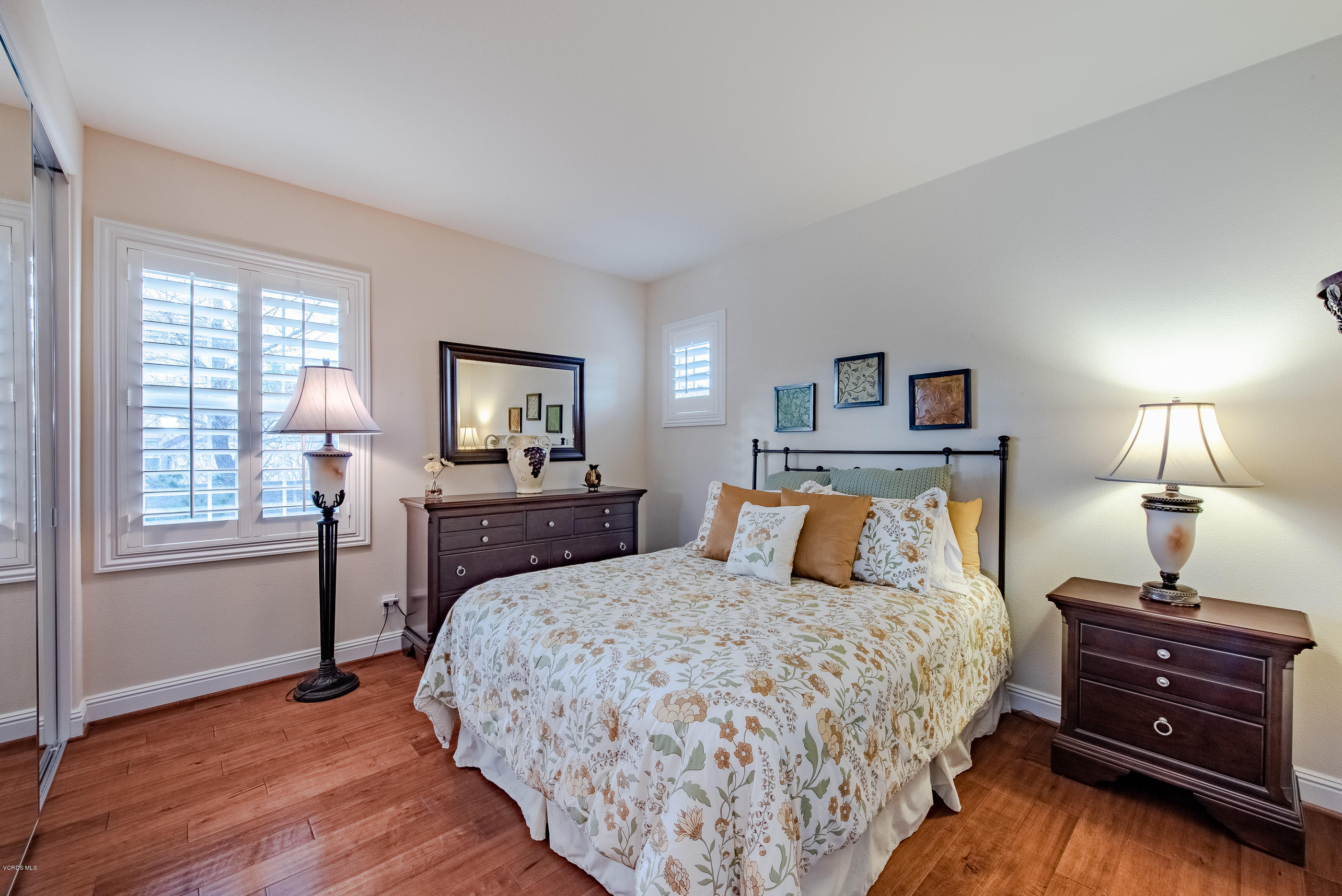 12354 Nelson Road Moorpark, CA 93021 - Photo 40 of 65 a bedroom with a bed and wooden floor
