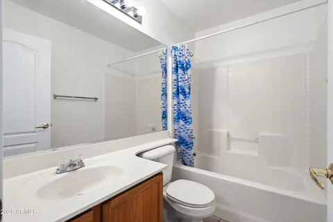 a bathroom with a double vanity sink toilet mirror and shower