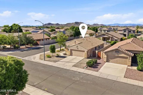 an aerial view of residential houses with outdoor space and mountain view