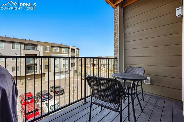 a view of a chairs and table in the balcony