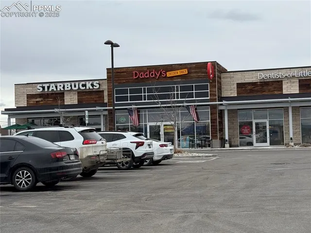 a view of a house with wooden fence