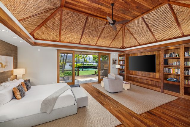 a bedroom with furniture and large window